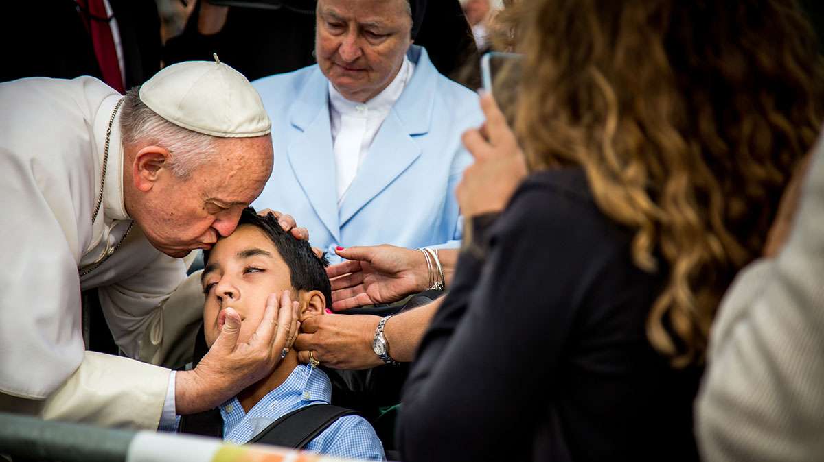  In this photo provided by World Meeting of Families, Pope Francis kisses and blesses Michael Keating, 10, of Elverson, Chester County,  after arriving in Philadelphia and exiting his car when he saw the boy Sept. 26. Michael has cerebral palsy and is the son of Chuck Keating, director of the Bishop Shanahan High School band that performed at Pope Francis' airport arrival. (Joseph Gidjunis/World Meeting of Families via AP)  