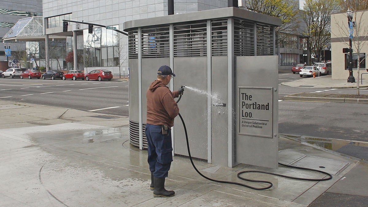  Rodney Haven, of Clean and Safe, washes down the exterior of a Portland Loo in Portland, Ore. The city installed solar-powered, stainless steel public toilets that its workers developed and dubbed the Portland Loo.  (AP Photo/Rick Bowmer, File) 