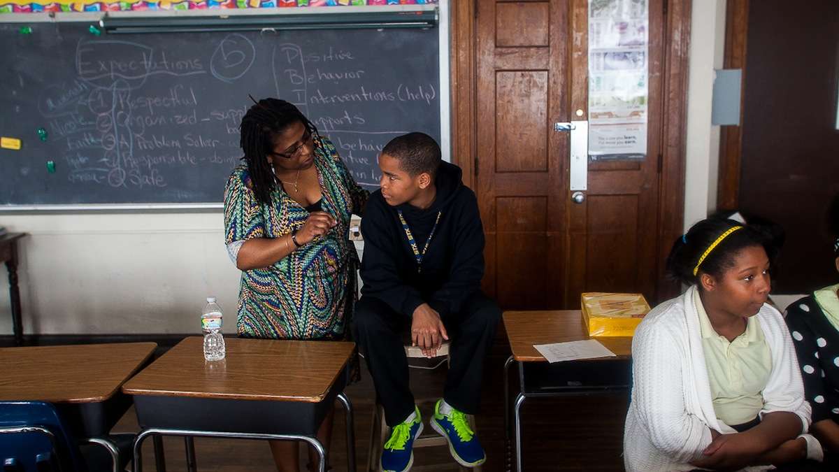  Roosevelt’s Cynthia Byron talks with sixth grader Zymeer Mcleod who helped put on the the Positive Behavior Intervention Supports (PBIS) presentation earlier in the day. (Brad Larrison/for NewsWorks) 