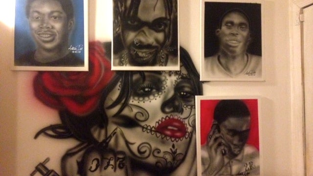  Tattoo artist Aaron 'Black Picasso' Ray paints portraits of some Wilmington homicide victims, giving them to families hoping to help them heal. (Anne Hoffman/for NewsWorks) 