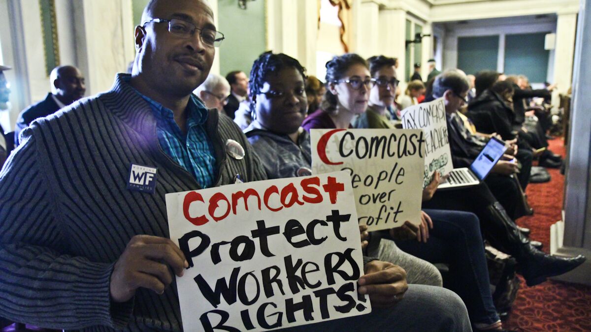  (From left) Will Dickens, Keidra Goldsmith, Len Glickman, and Hannah Sassaman with Working Families are present during a meeting at which city council votes on whether the city of Philadelphia will make a deal with Comcast. (Kimberly Paynter/WHYY) 