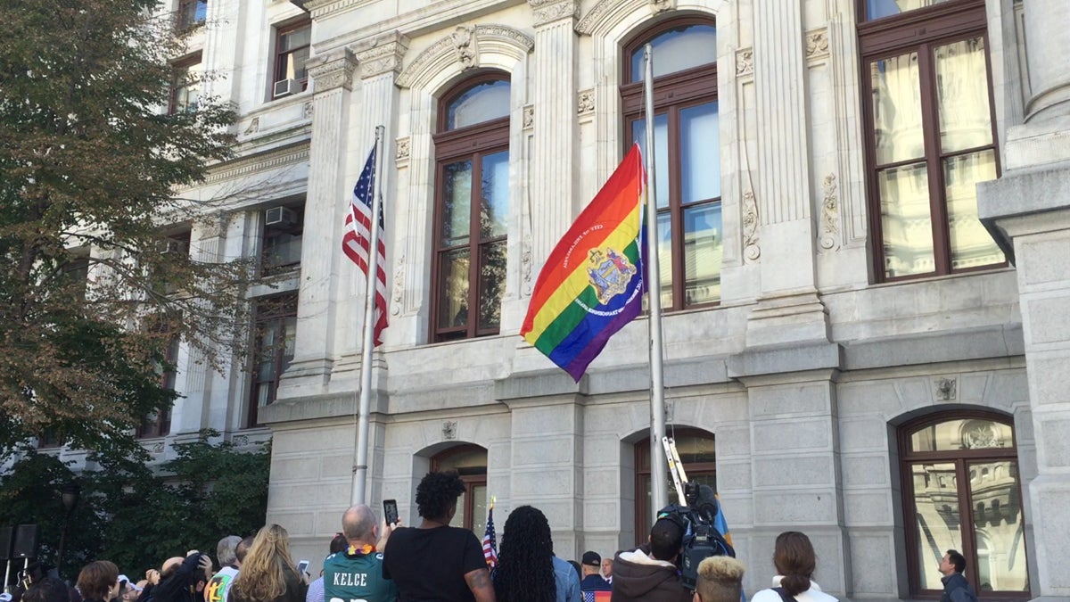 The city's pride flag is raised outside of Philadelphia City Hall in October 2015. (Eric Walter/WHYY
