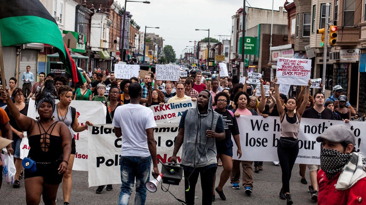 Coalition for REAL Justice marches through North Philadelphia Friday evening. (Brad Larrison/for NewsWorks)
