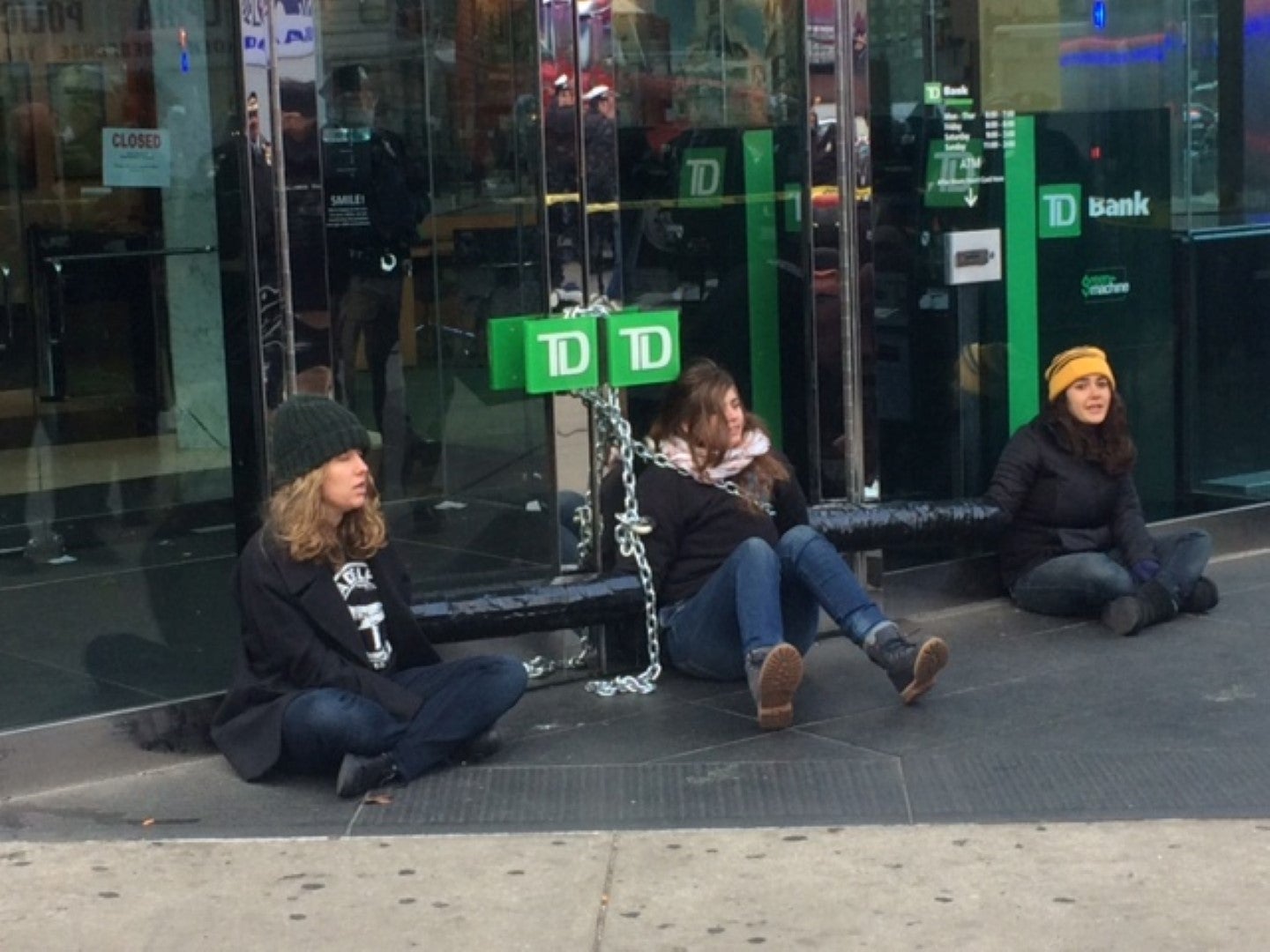 Three protestors use heavy chain to bind themselves to Center City TD Bank
(Tom MacDonald