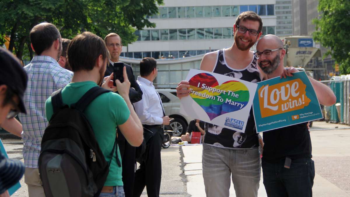  Brad Strong and Anthony Reisinger of Cheltenham, Pa., married four years ago in Washington, D.C. On Tuesday, they attended a rally at City Hall to celebrate a federal court decision overturning Pennsylvania's ban on same-sex marriage. (Emma Lee/WHYY) 