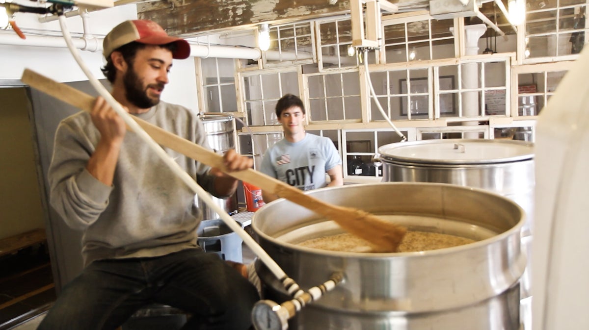  Distillers Brian Forrest and Zach Cohen brew grain at Red Brick Craft Distillery in Kensington. (Kimberly Paynter/WHYY) 