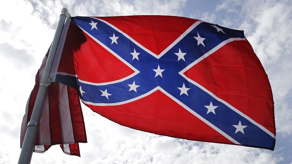  A Confederate flag similar to this one flying in South Carolina was stolen from a Newark home this week. Three teens now face theft charges. (AP Photo/John Bazemore) 