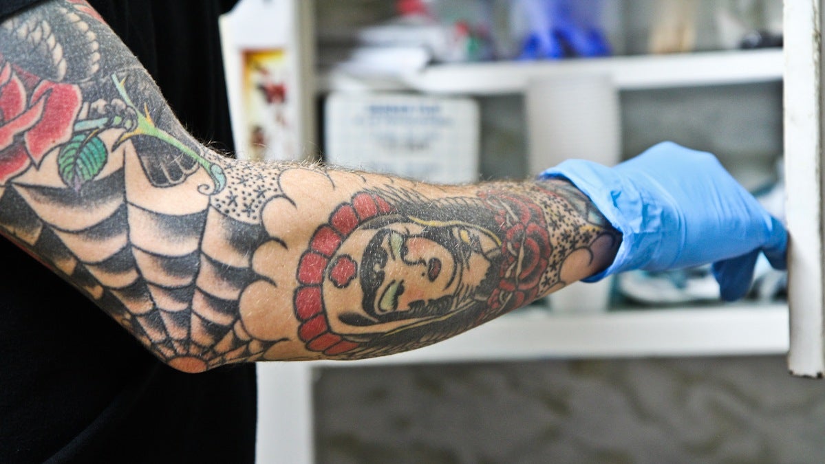 Tattoo artist Kyle Fitzpatrick enjoys the 'flash' or traditional style of tattooing. He said he's had his own tattoos for over ten years. (Kimberly Paynter/WHYY)