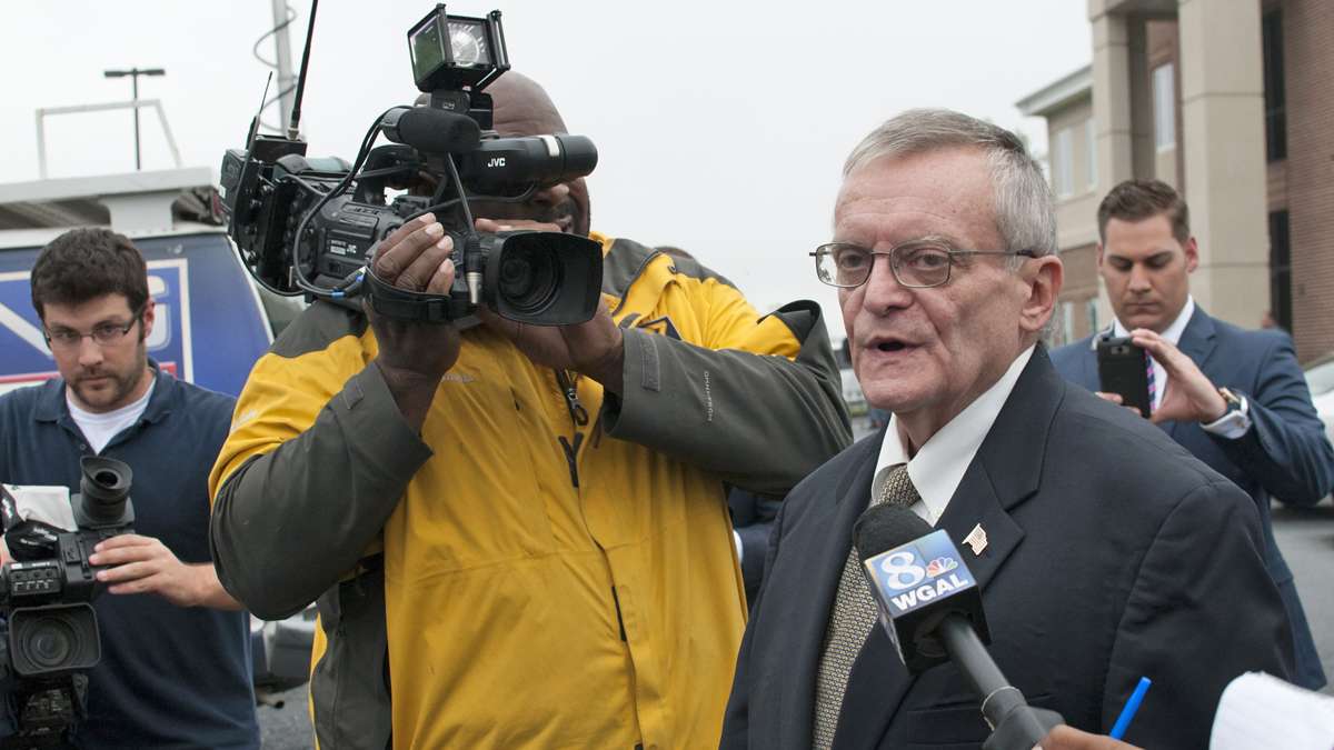  Reporters flank former Harrisburg Mayor Stephen Reed after his arrest on bribery, theft and corruption charges. (Diana Robinson/WITF) 