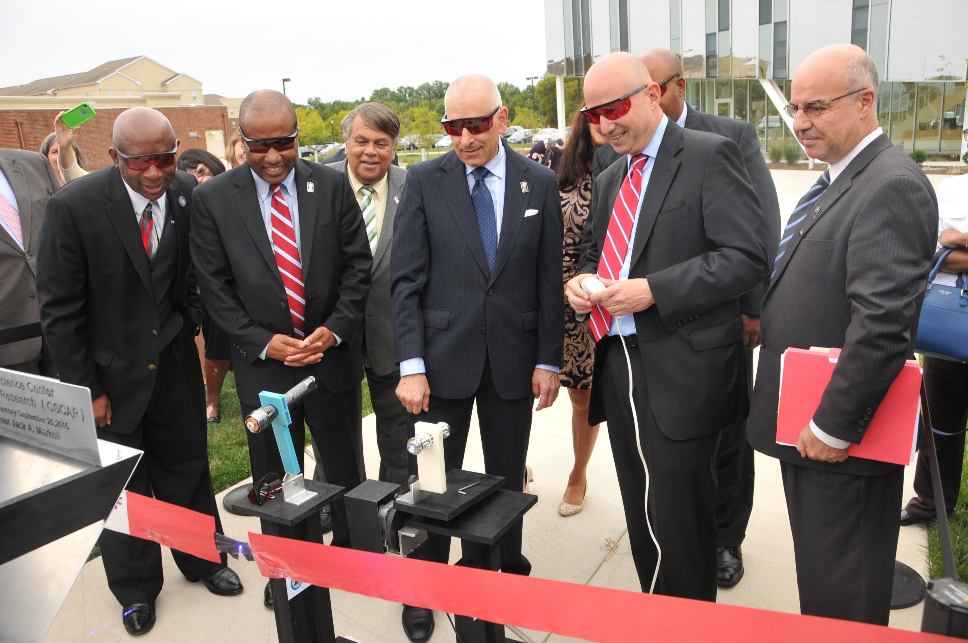  Governor Jack Markell (second from right) cuts the ceremonial ribbon using a laser. (Photo courtesy of Delaware State University) 