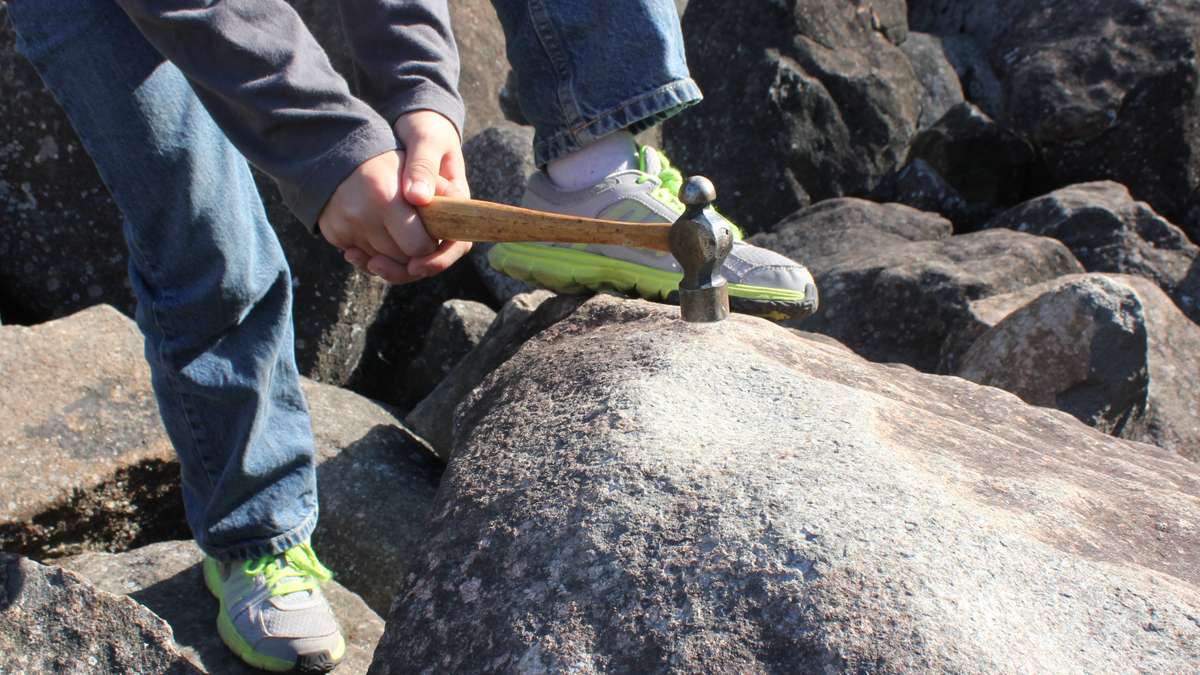  Kids visiting Ringing Rocks Parks use their hammers to find the rocks — about one in six — that produce sounds almost like wind chimes. (Emma Jacobs/WHYY) 