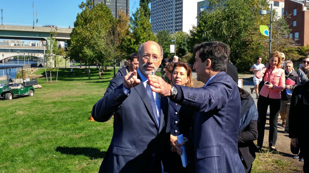 Gov. Tom Wolf and Philadelphia Managing Director Michael DiBerardinis meet on the banks of the Schuylkill River to announce a $3 million state grant to extend the Schuylkill River Trail. (Tom MacDonald/WHYY)