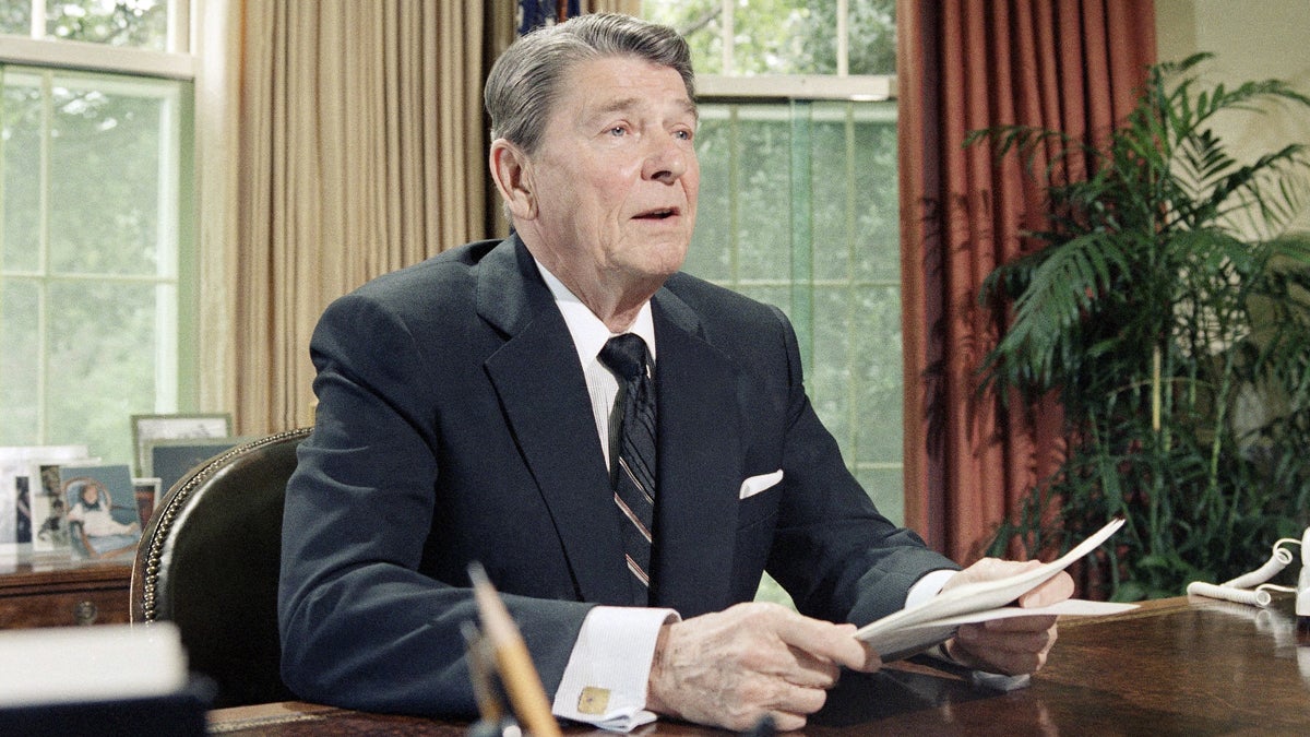  President Reagan is shown during a 1986 televised speech from the Oval Office. (AP Photo/Barry Thumma, file) 