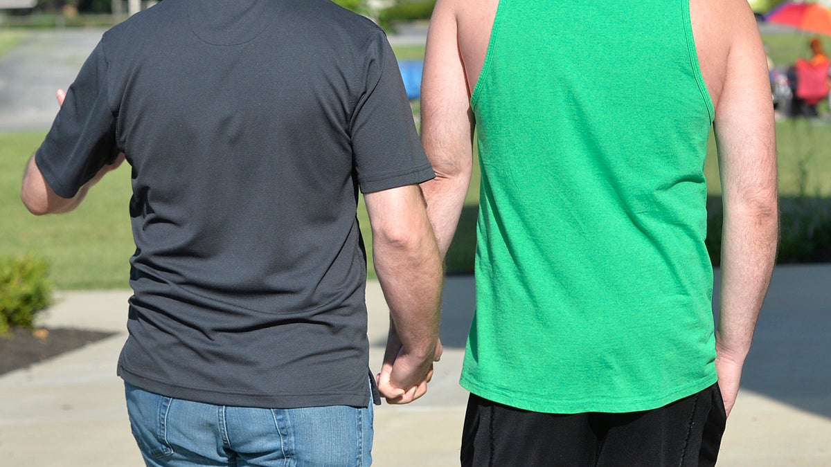 James Yates, left, and William Smith Jr. head into the Rowan County Courthouse to obtain a marriage license in Morehead, Ky., Thursday, Aug. 13, 2015. In a decision on Wednesday, U.S. District Judge David L. Bunning ordered Rowan County Clerk Kim Davis to issue marriage licenses, but she has refused after filing an appeal to the ruling to the Sixth Circuit Court of Appeals. (AP Photo/Timothy D. Easley)