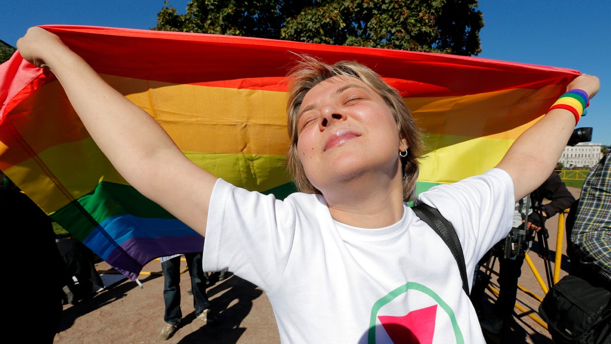 Gay rights activist Natalia Tsybalova, holds a rainbow flag during a picket in downtown St. Petersburg, Russia, Friday, Sept. 6, 2013. (AP Photo/Dmitry Lovetsky) 