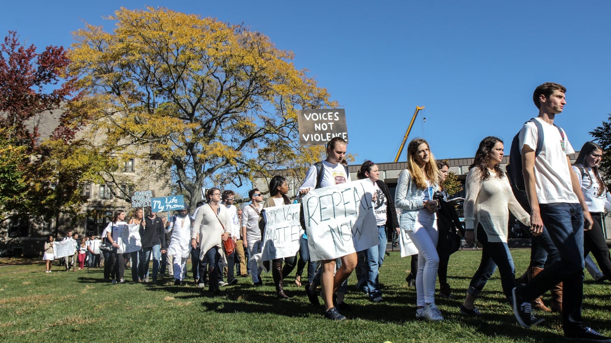 Villanova University students and faculty meet march on campus to protest the school’s decision to arm their Public Safety officers. (Kimberly Paynter/WHYY)