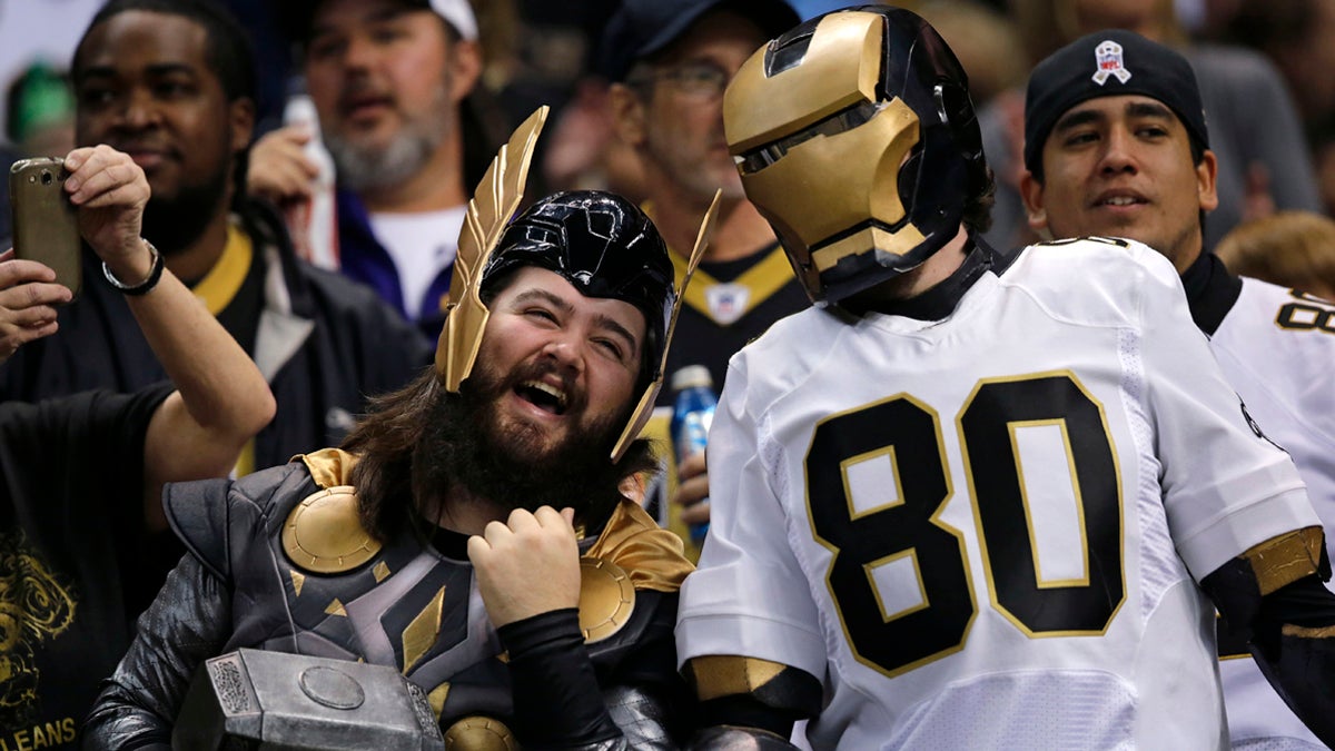  New Orleans Saints fans cheer in the first half of an NFL football game, Sunday, Dec. 29, 2013. Philadelphia police say a few officers may dress as Saints fans to keep the peace during the Eagles playoff game Saturday night.  (AP Photo/Bill Feig) 