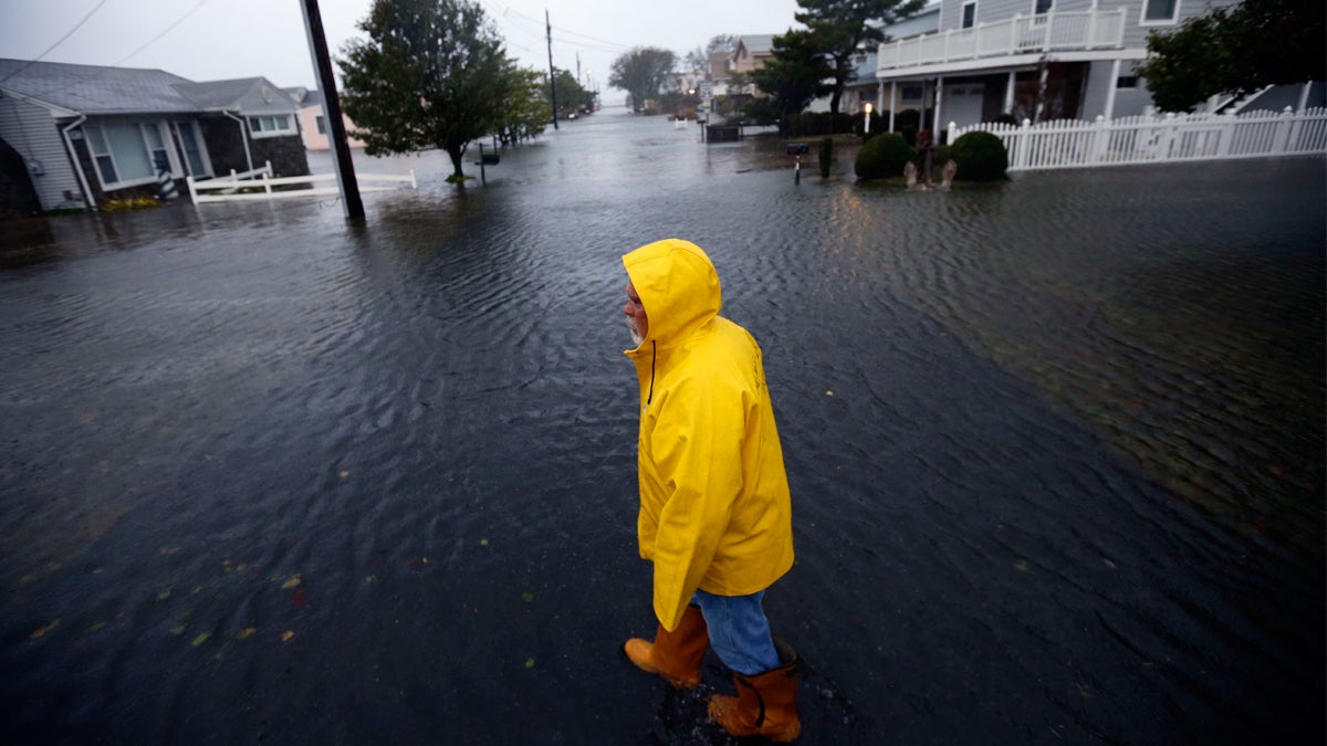  Al Daisey walks in the flood water in front of his home as Hurricane Sandy bears down on the East Coast, Monday, Oct. 29, 2012, in Fenwick Island, Del. (Alex Brandon/AP Photo, file) 