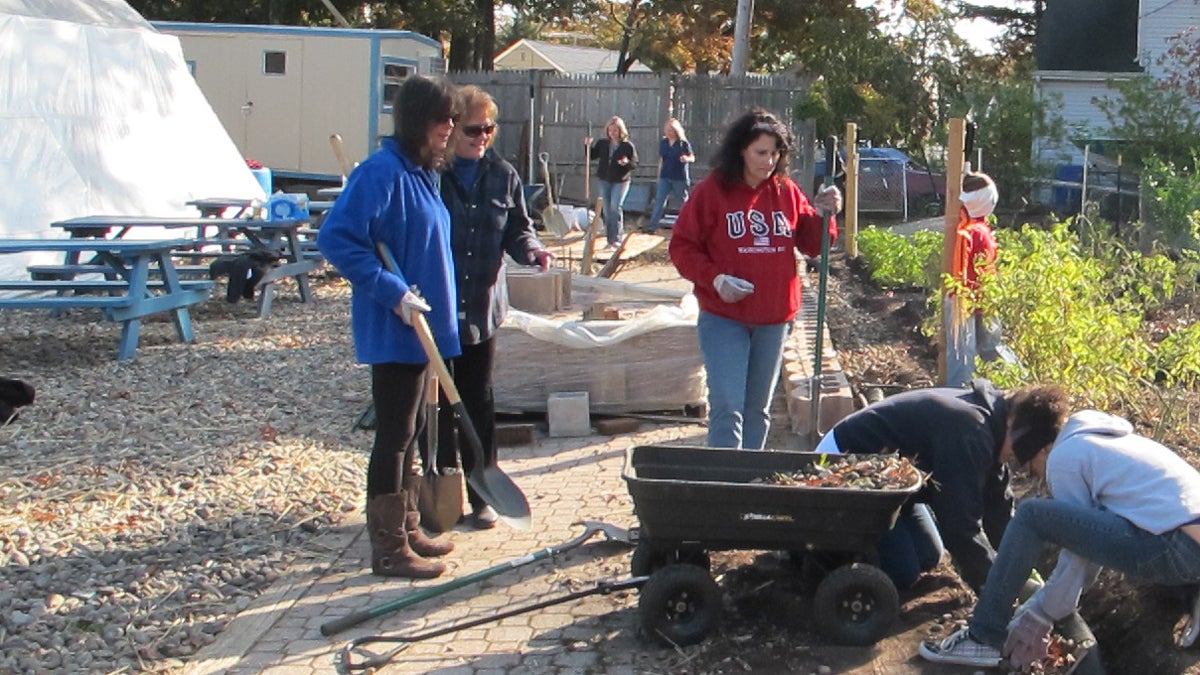  Volunteers help build a wall at a community garden at Sandy Service Day project in Brick Township (photo by Phil Gregory). 