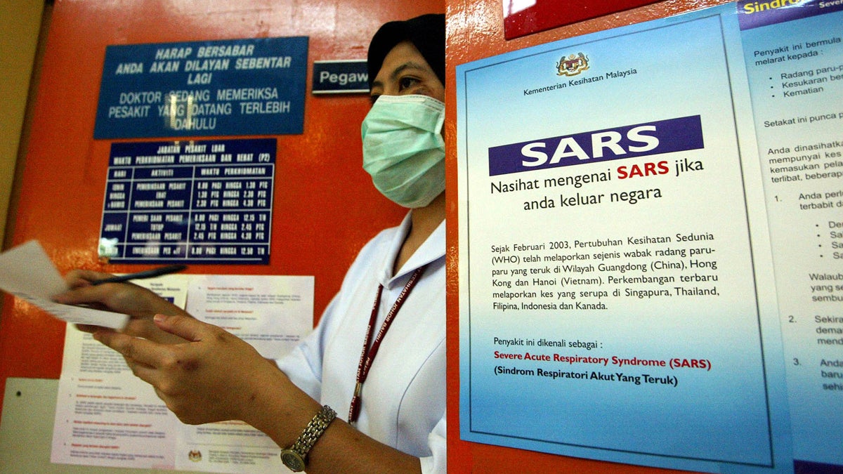 A hospital worker wears a surgical mask to protect herself from severe acute respiratory syndrome