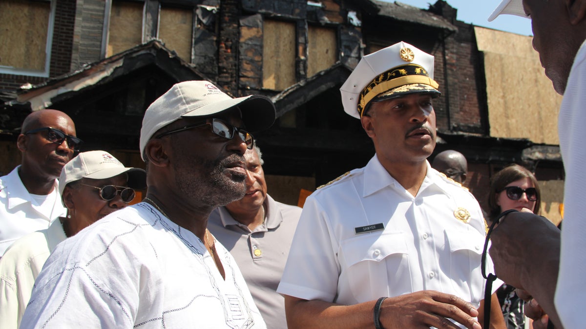  Philadelphia Fire Commissioner Derrick Sawyer meets with residents of Gesner Street, where a fire claimed the lives of four children. (Emma Lee/WHYY) 