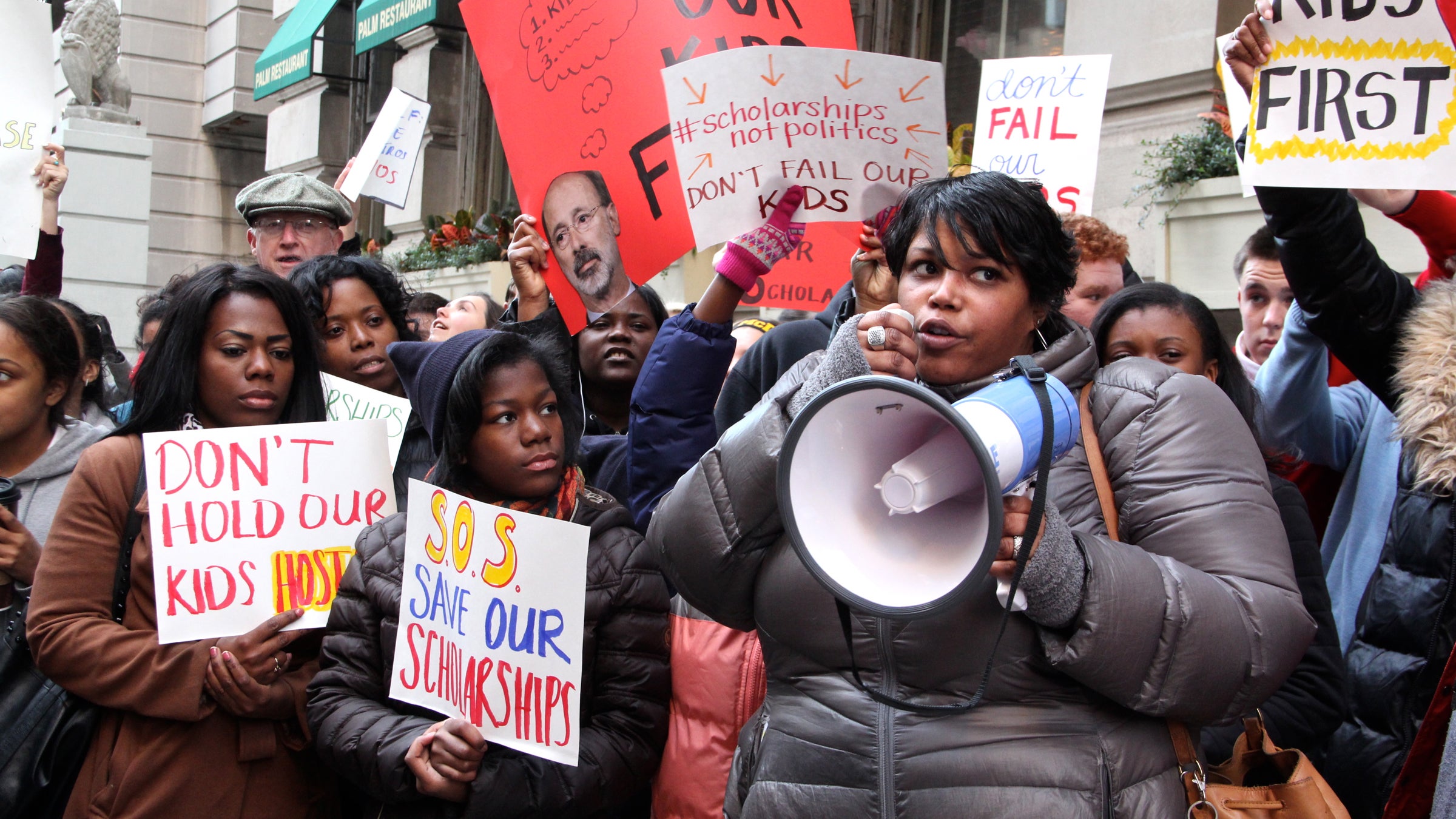  Students, parents and education advocates attend a rally outside Gov. Tom Wolf's Philadelphia offices to pressure the administration to lift restrictions on the Educational Improvement Tax Credit that provides scholarships to low-income students. (Emma Lee/WHYY) 