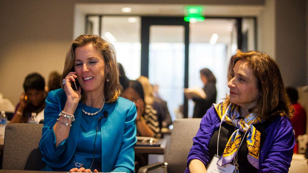  Katie McGinty, chief of staff to Gov. Tom Wolf, speaks with the recipient of a scholarship Thursday after calling his home. At her right is Ina Lipman, executive director of the scholarship fund. (Brad Larrison/for NewsWorks) 