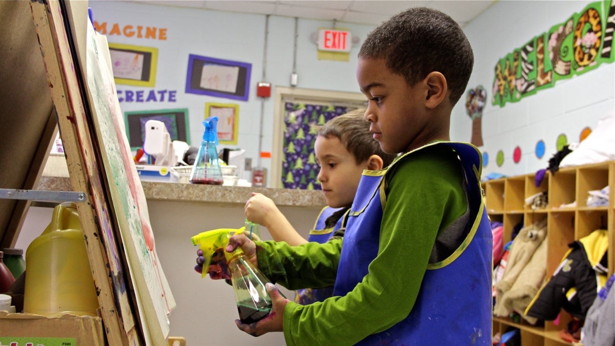 Preschoolers paint together using spray bottles at Paley Early Learning Center in Northeast Philadelphia. (Emma Lee/WHYY