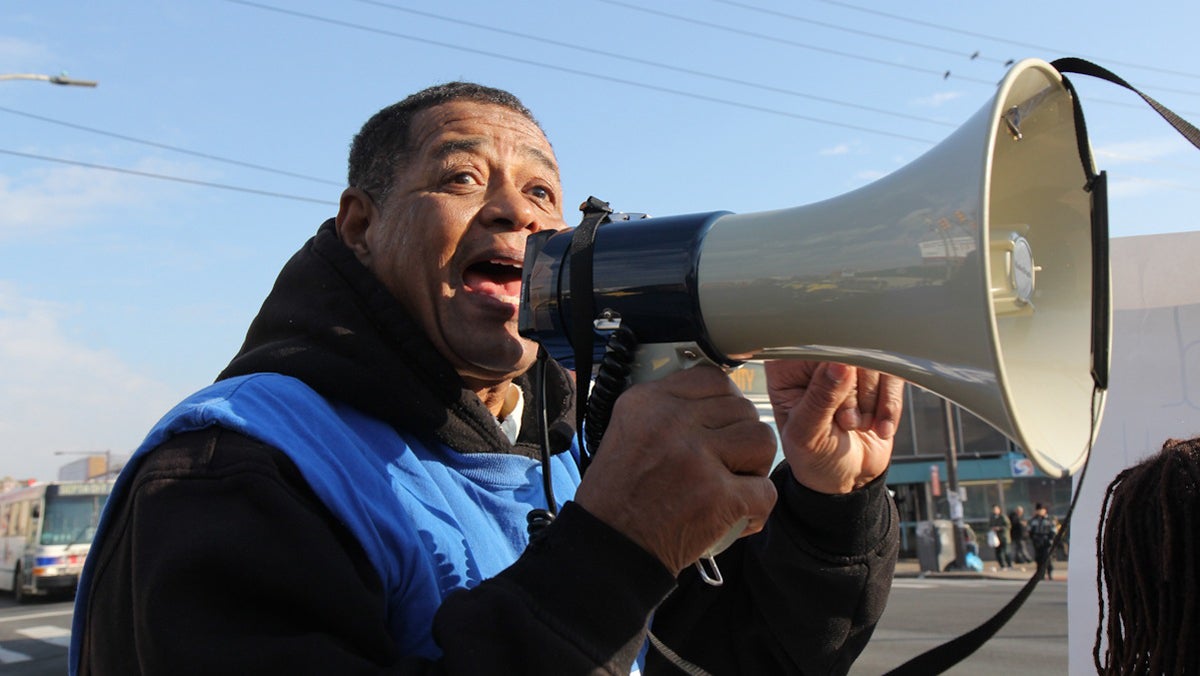  Ronald Armour, a community activist with Action Untied, takes a megaphone to the street to encourage others to join supporters of more funding for Philly schools on a march to Central High School. (Kimberly Paynter/WHYY) 