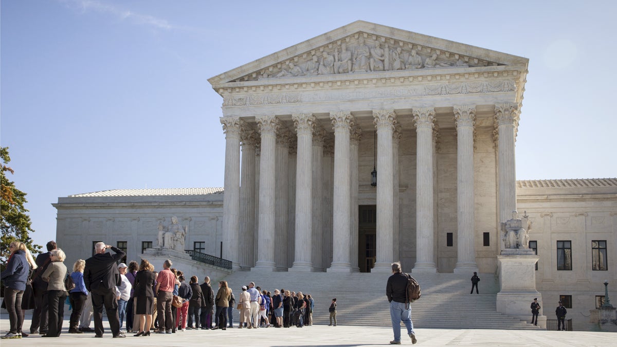 People wait to enter the Supreme Court in Washington
