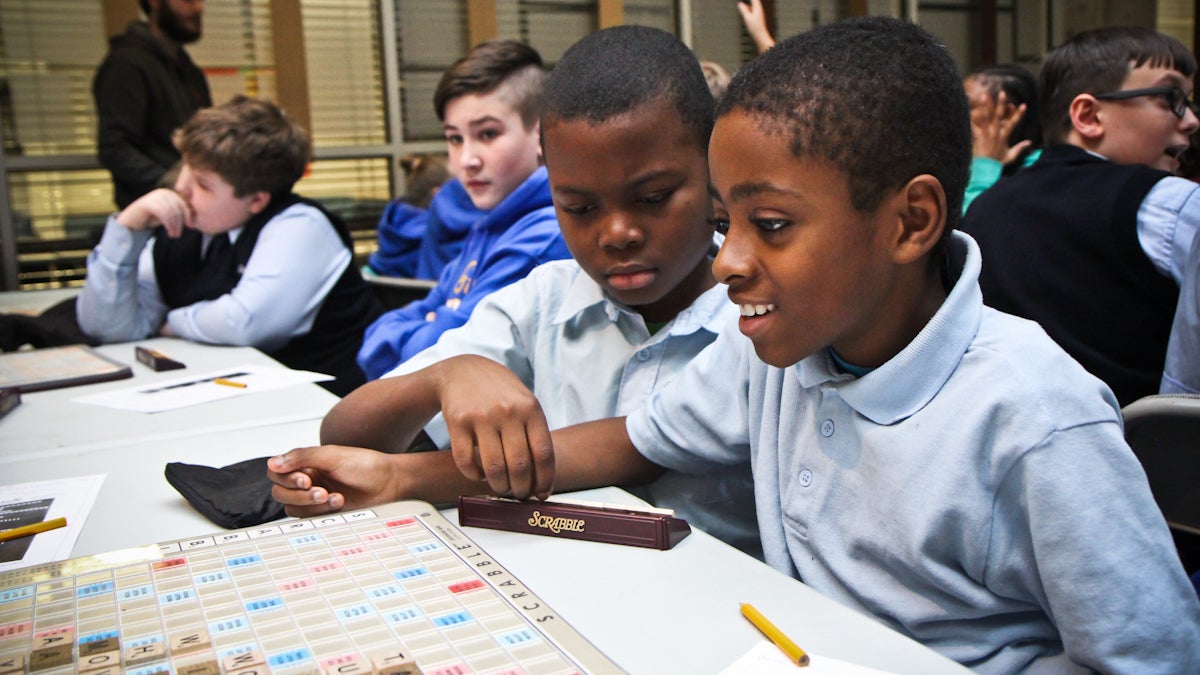 Kyseem Taylor, 10, and Tashan Watson, 11, of Richard R. Wright elementary play Scrabble in a tournament at school district headquarters Wednesday afternoon. (Kimberly Paynter/WHYY)
