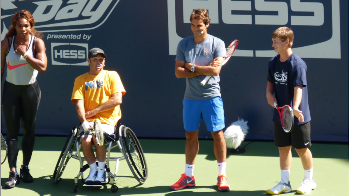  Kyle Seelig (right), who represented East Falls' Legacy Youth Tennis and Education at Arthur Ashe Youth Day at the U.S. Open, competed against Serena Williams, Roger Federer and the winner of wheelchair-tennis competition in a target-hitting competition last Saturday. (Photo courtesy of the U.S. Open) 