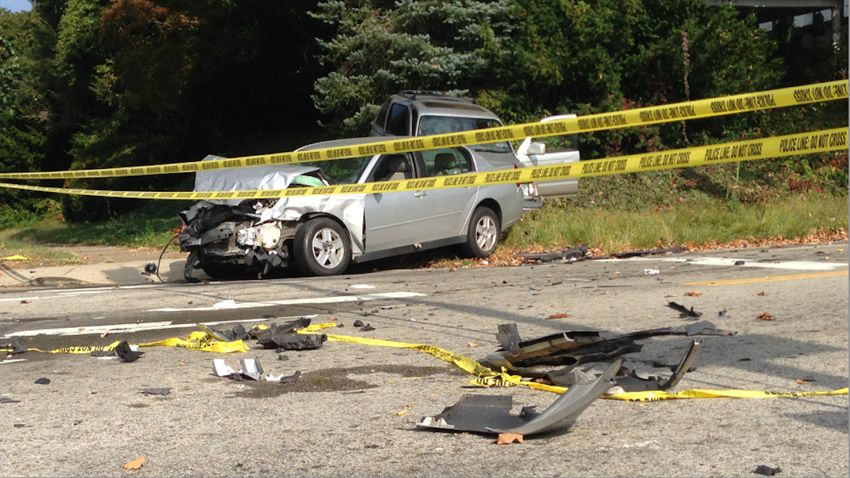  Debris from the early morning crash still littered the Henry Ave. and West Queen Lane intersection hours later. (Brian Hickey/WHYY) 