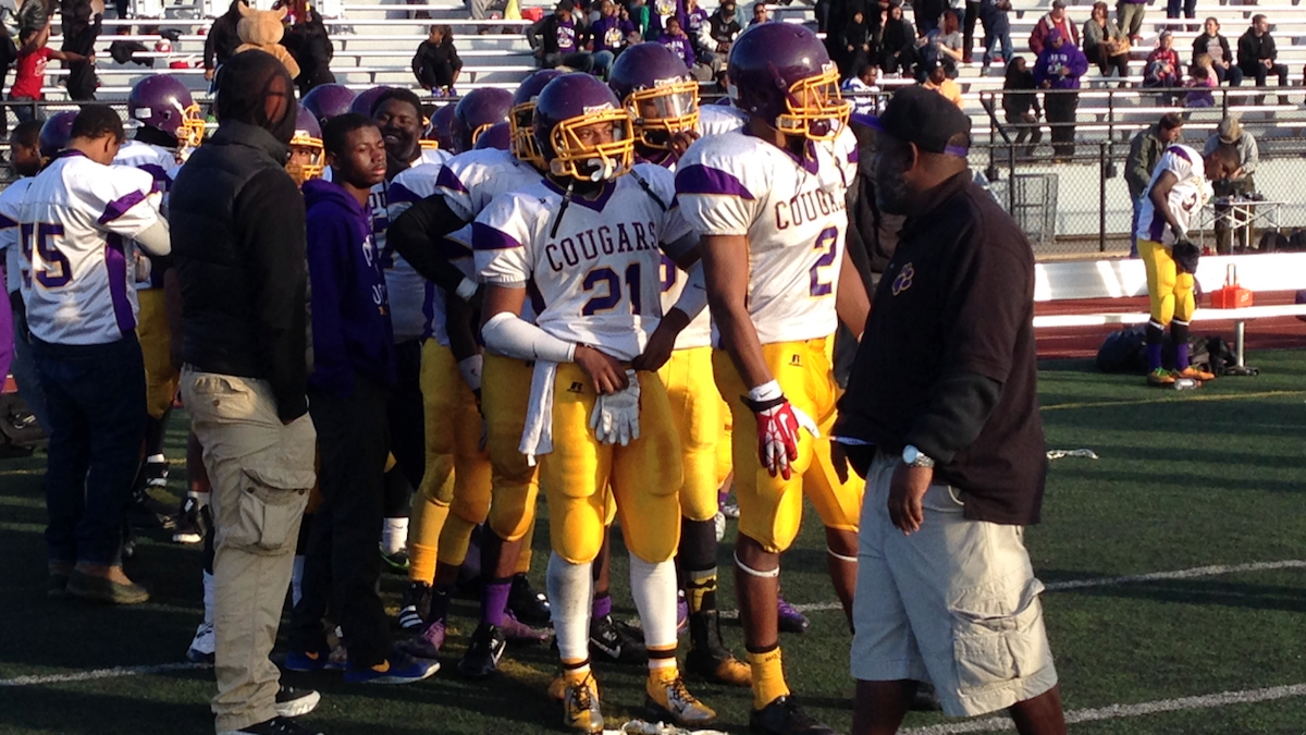  The MLK Cougars line up to congratulate the Archbishop Wood Vikings who defeated them 52-8 in the PIAA AAA District 12 Championship Game on Saturday. (Brian Hickey/WHYY) 