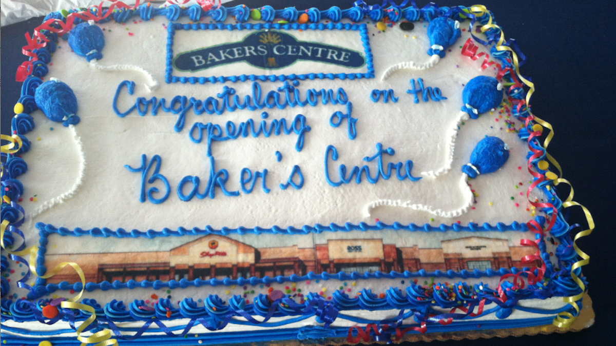  The atmosphere was so festive at the Bakers Centre ribbon-cutting event that few were likely to notice the errant apostrophe on the cake. (Laura Benshoff/for NewsWorks) 