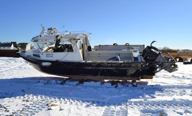 The boat occupied by beach replenishment surveyors that capsized off Sea Girt Saturday morning. (Image: Sea Girt Police Department)  