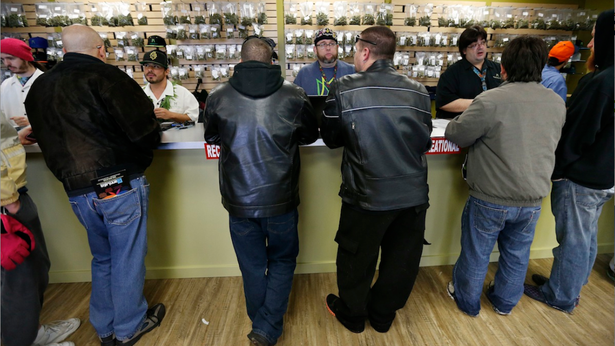  Employees help customers at the crowded sales counter inside the Medicine Man marijuana retail store in Denver. But is legalization the best path? (AP Photo/Brennan Linsley, File) 