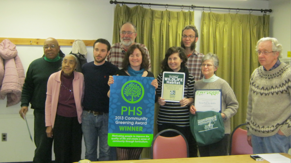  Recipients posed with the blue-and-green sign that touts the Vernon Park rain garden for 