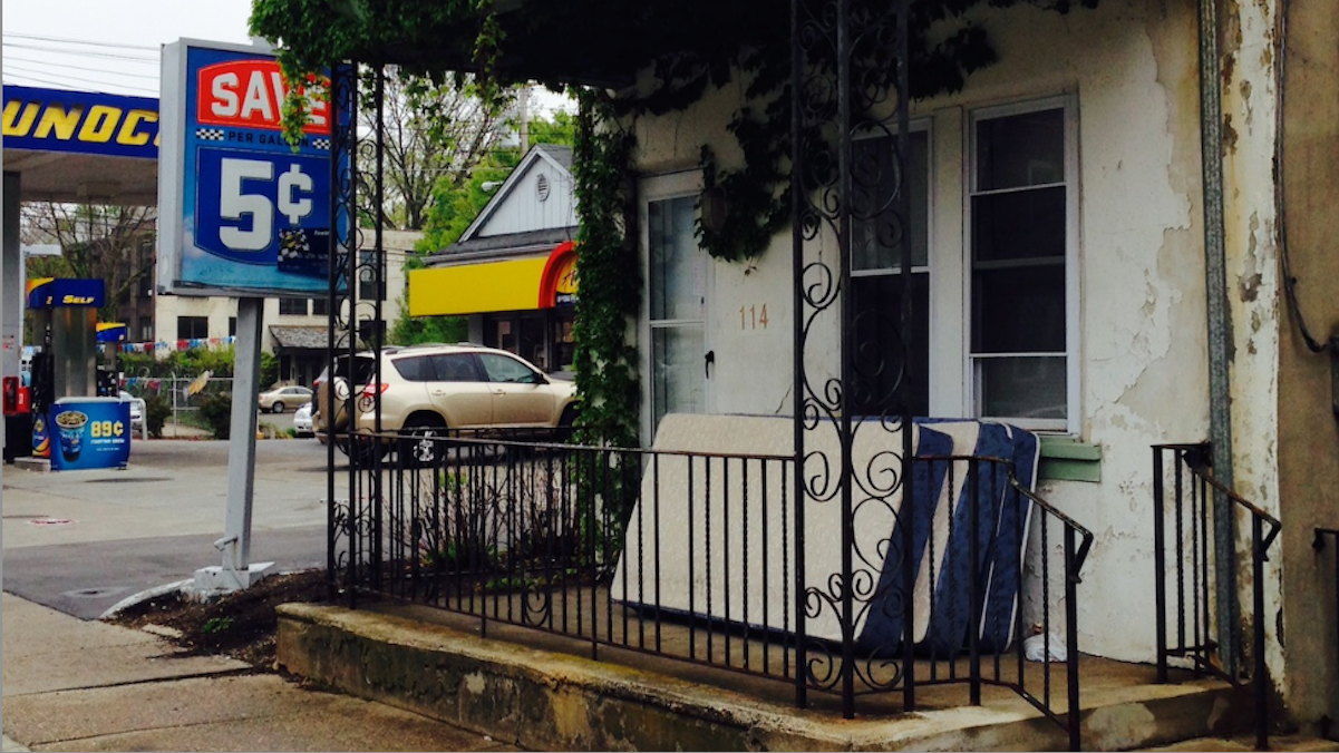  The home where an explosion cost Douglas Ferrin several fingers Wednesday morning sits next to a Sunoco gas station in Germantown. (Brian Hickey/WHYY) 