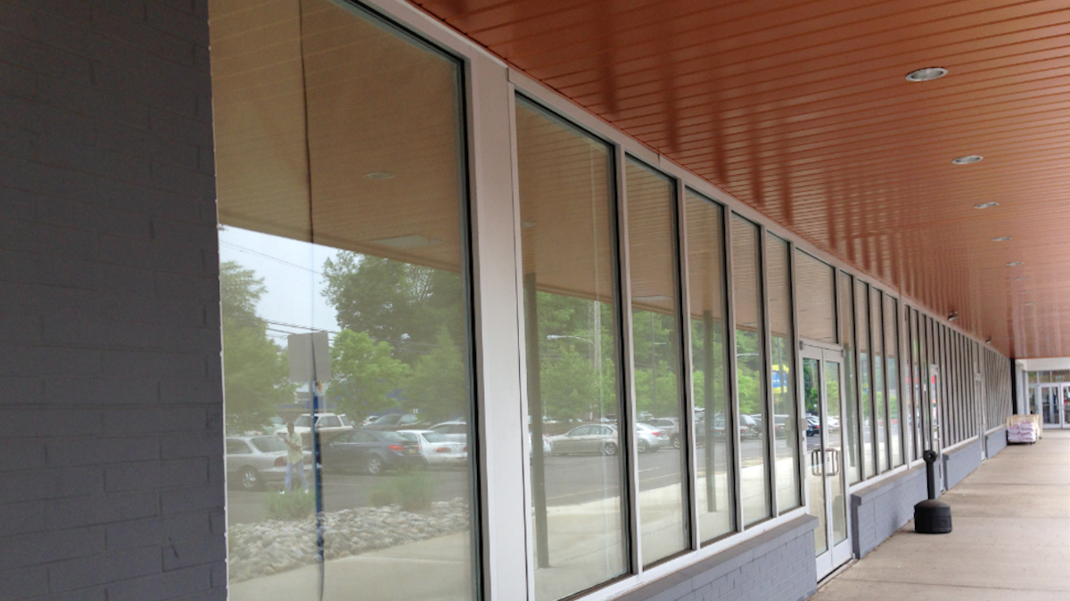  Once heralded as a 'tipping point' for Germantown revitalization, windows at the Citibank branch in Chelten Plaza are now papered over. (Brian Hickey/WHYY) 
