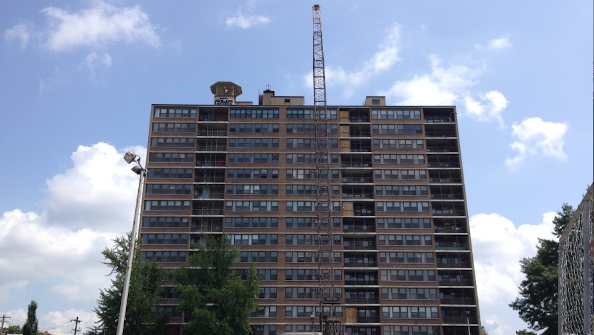  Activity at the Queen Lane Apartments site now sees a crane standing taller than the high-rise building. (Brian Hickey/WHYY) 