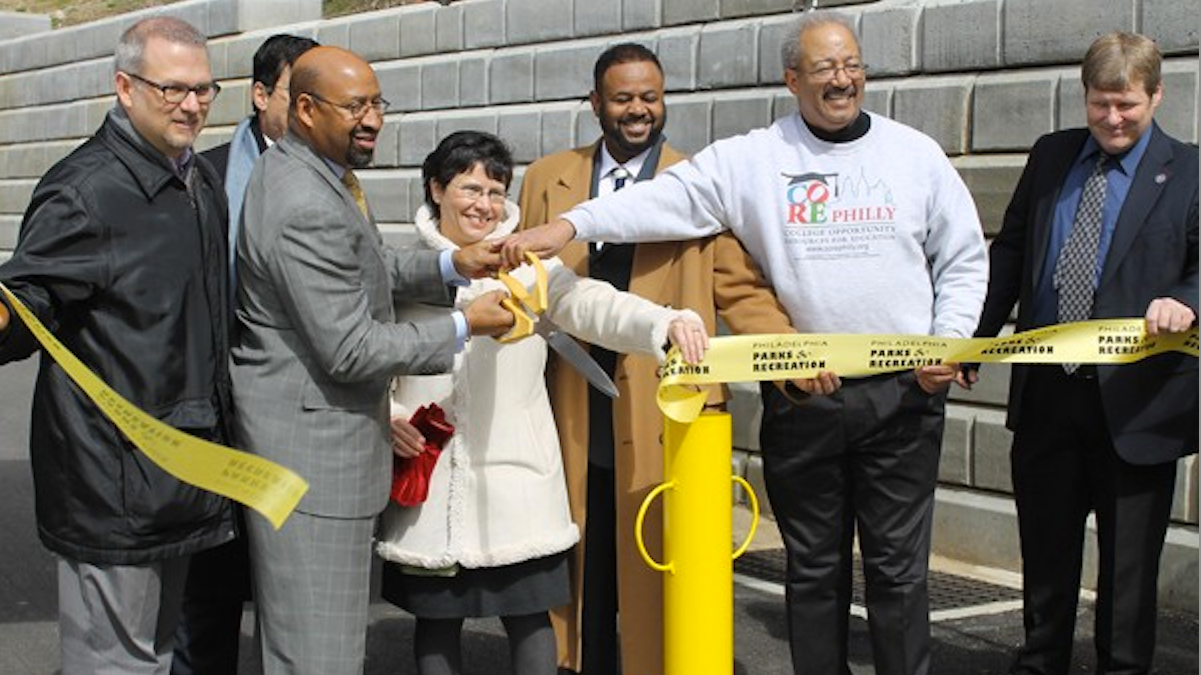  Mayor Michael Nutter and U.S. Rep. Chaka Fattah hold oversized scissors at the 2013 ribbon cutting for the Shawmont Trail project in Northwest Philadelphia. (NewsWorks, file art) 