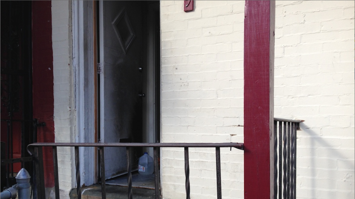  This Germantown front porch was the scene of an alleged firebombing early Monday morning. (Brian Hickey/WHYY) 