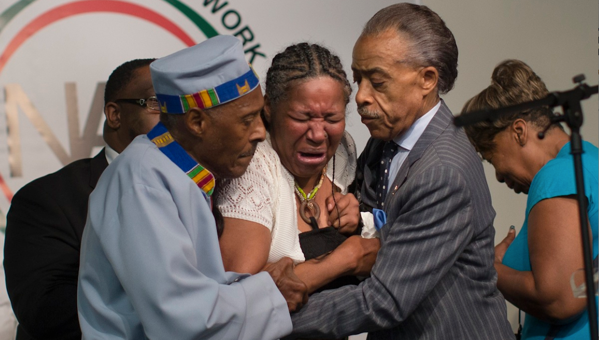  Esaw Garner, wife of Eric Garner, breaks down in the arms of Rev. Herbert Daughtry, center, and Rev. Al Sharpton, right, during a July rally at the National Action Network headquarters for Eric Garner. (AP Photo/John Minchillo) 