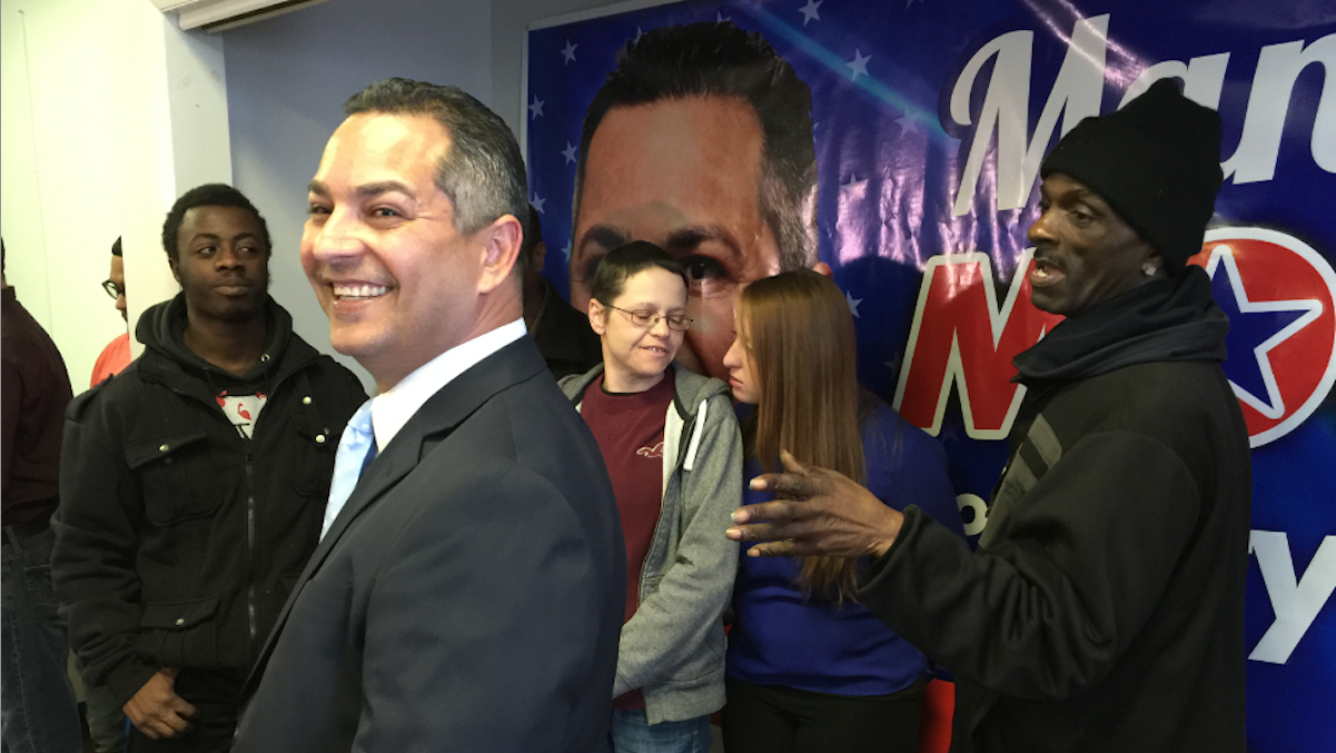  Seventh District council candidate Manny Morales flanked by supporters at Friday's press conference in his Hunting Park Avenue campaign office. (Brian Hickey/WHYY) 