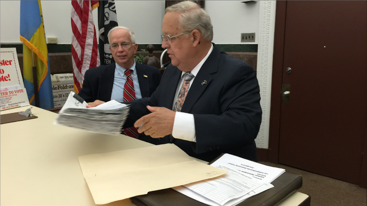  Independent mayoral candidate James Foster hands in his nominating petitions at the county Board of Elections office on Monday morning. (Brian Hickey/WHYY) 