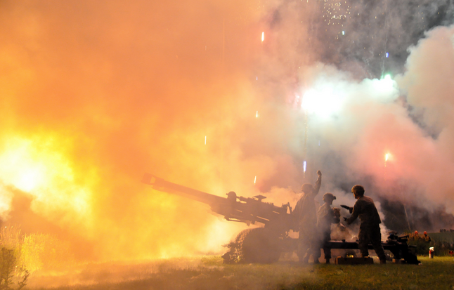  Soldiers from the Wisconsin Army National Guard's 1st Battalion, 120th Field Artillery fire powder charges from a M119A2 towed 105-mm  howitzer on July 2, 2011.  (Wisconsin National Guard photo by 1st Sgt. Vaughn R. Larson) 