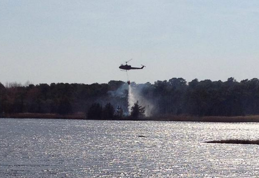  A New Jersey Forest Fire Service helicopter dropping water over a wildfire off Jordan Road in Brick Sunday afternoon. (Photo: Jersey Shore Hurricane News contributor Josh Bickert) 