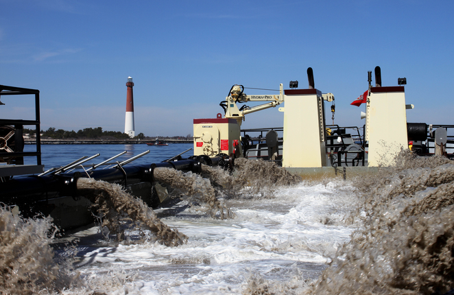  The MURDEN, a shallow draft dredge vessel, clears shoaling from the Barnegat Inlet in April 2014. The vessel was designed by the U.S. Army Corps of Engineers' Marine Design Center in Philadelphia and is based out of Wilmington, N.C. The Barnegat Inlet requires dredging to provide reliable maritime navigation for the U.S. Coast Guard and a large fishing fleet consisting of full-time commercial, charter, and recreational vessels. (Photo: Tim Boyle) 