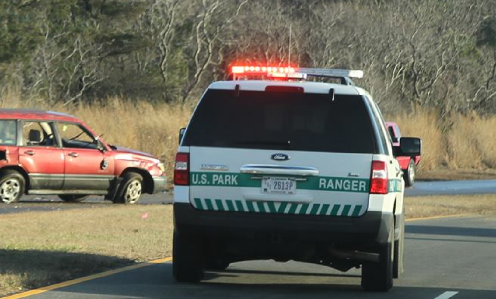  A U.S. Park Ranger on the scene of a two vehicle crash this afternoon in Sandy Hook. One of the vehicles in the crash is on the left. Photo courtesy of JSHN contributor Bill Senck. 